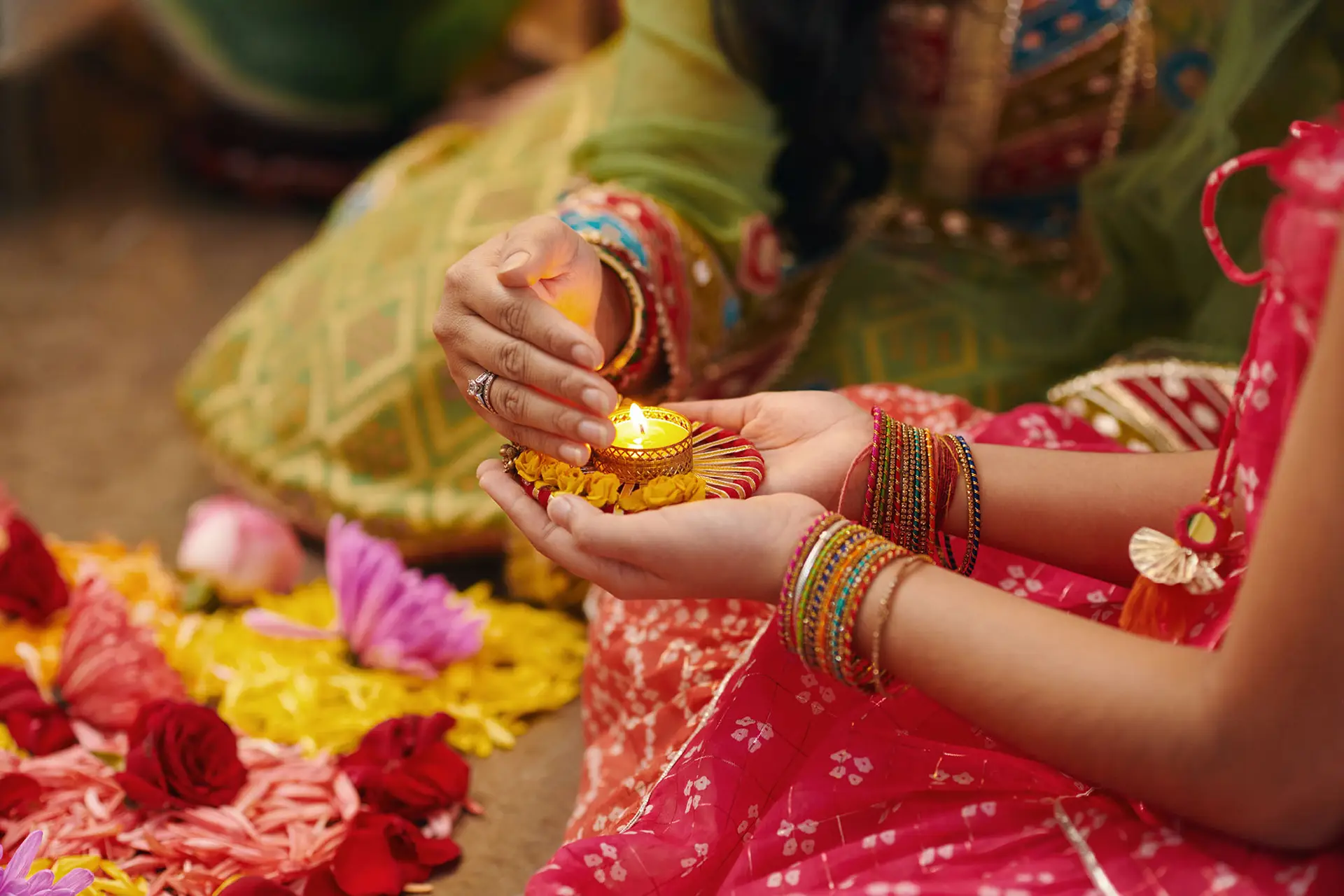 Indian family lighting candle at traditional holiday