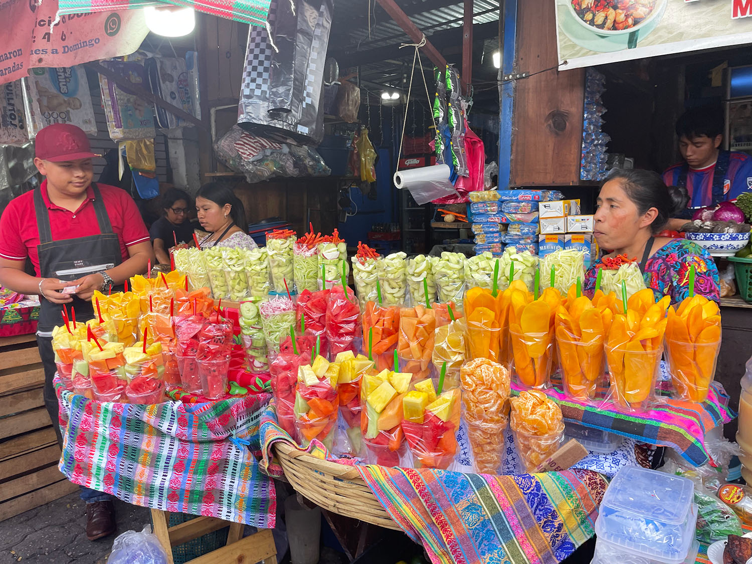 Woman selling cut fruit at Antigua's central market